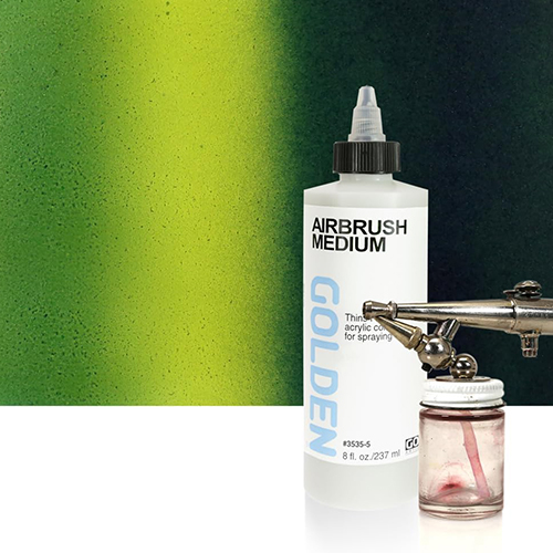 A tube of golden airbrush medium alongside a profe